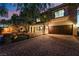 Two-story house with brown garage door, landscaping, and brick driveway at 11017 Ladyburn Ct, Las Vegas, NV 89141