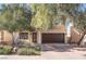 Two-story house with brown garage door and landscaped yard at 11017 Ladyburn Ct, Las Vegas, NV 89141