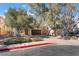 Two-story house with brown garage door and brick driveway, surrounded by trees at 11017 Ladyburn Ct, Las Vegas, NV 89141