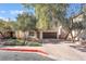 Two-story house with brown garage door and brick driveway, surrounded by trees at 11017 Ladyburn Ct, Las Vegas, NV 89141