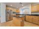 Spacious kitchen with island, stainless steel appliances, and light wood cabinets at 11017 Ladyburn Ct, Las Vegas, NV 89141