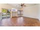 Living room with tile floors, ceiling fan, and sliding glass doors to backyard at 11017 Ladyburn Ct, Las Vegas, NV 89141