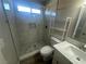 Updated bathroom with a walk-in shower and marble tile at 124 Winley Chase Ave, North Las Vegas, NV 89032