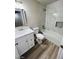 Bathroom with white vanity, marble tile, and bathtub at 124 Winley Chase Ave, North Las Vegas, NV 89032