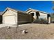 One-story house with a two-car garage and gravel landscaping at 124 Winley Chase Ave, North Las Vegas, NV 89032