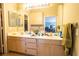 Double vanity bathroom with light wood cabinets at 1429 Daybreak Dr, Las Vegas, NV 89108