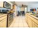 Bright kitchen features ample cabinetry and a tile floor at 1429 Daybreak Dr, Las Vegas, NV 89108