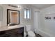 Clean bathroom with dark brown vanity and bathtub at 1510 Marita Dr, Boulder City, NV 89005