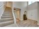 Bright entryway with laminate flooring, staircase, and double doors at 1510 Marita Dr, Boulder City, NV 89005