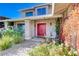 Front entry with red door, brick wall, and walkway at 1510 Marita Dr, Boulder City, NV 89005