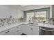 Modern kitchen with white cabinets, quartz countertops, and a large window at 1510 Marita Dr, Boulder City, NV 89005