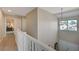 Upper hallway with white railings and a view into a bedroom at 1510 Marita Dr, Boulder City, NV 89005