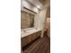 Bathroom with double vanity, large mirror, and laminate flooring at 1529 Tillman Falls Ave, Las Vegas, NV 89183