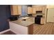 L-shaped kitchen with granite countertops and wood cabinets at 1529 Tillman Falls Ave, Las Vegas, NV 89183