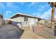 Single story house with gravel driveway and chain link fence at 1641 Stewart Ave, Las Vegas, NV 89101