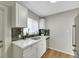 Clean and updated kitchen with white cabinets and a gray tile backsplash at 1641 Stewart Ave, Las Vegas, NV 89101