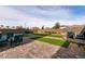 Artificial turf backyard with brick patio and seating areas at 1642 Dire Wolf Ave, North Las Vegas, NV 89084