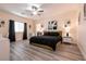 Spacious bedroom with large bed, wood-look floors, and stylish decor at 1642 Dire Wolf Ave, North Las Vegas, NV 89084