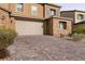 Brick paved driveway leading to a two-car garage at 1642 Dire Wolf Ave, North Las Vegas, NV 89084