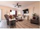 Relaxing living room with a ceiling fan, large TV, and comfortable seating at 1642 Dire Wolf Ave, North Las Vegas, NV 89084