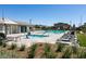 Community pool with spa, lounge chairs, and pool house at 1642 Dire Wolf Ave, North Las Vegas, NV 89084