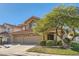 Two-story house with three-car garage and landscaped yard at 1901 Summit Pointe Dr, Las Vegas, NV 89117