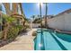 Inviting turquoise pool with a rock waterfall feature, surrounded by a spacious patio at 1901 Summit Pointe Dr, Las Vegas, NV 89117