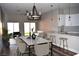 Open concept dining room with marble table and modern chandelier at 1908 Quail Point Ct, Las Vegas, NV 89117