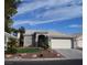 Single-story home with tile roof, landscaping, and a two-car garage at 1908 Quail Point Ct, Las Vegas, NV 89117