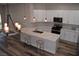 Modern kitchen with white cabinets, quartz countertops, and island at 1908 Quail Point Ct, Las Vegas, NV 89117