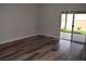 Bright living room features wood-look floors and sliding glass doors to backyard at 1908 Quail Point Ct, Las Vegas, NV 89117