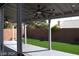 Covered patio with ceiling fan, artificial turf, and a view of the backyard at 1908 Quail Point Ct, Las Vegas, NV 89117