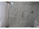 Walk-in shower with marble tile and glass enclosure at 1908 Quail Point Ct, Las Vegas, NV 89117