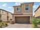 Tan two-story house with a two-car garage and nicely landscaped front yard at 1937 Shanon Michelle Ave, North Las Vegas, NV 89031