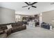 Open concept living room and kitchen with brown sectional sofa and island at 1937 Shanon Michelle Ave, North Las Vegas, NV 89031