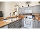 Modern kitchen featuring granite countertops and white cabinets at 2050 N Los Feliz St # 172, Las Vegas, NV 89156