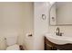 Updated bathroom with a dark vanity and an arched mirror at 2077 Via Firenze, Henderson, NV 89044