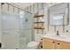 Stylish bathroom with vertical striped wallpaper and floating shelves at 2077 Via Firenze, Henderson, NV 89044