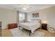 Serene bedroom featuring a comfy bed, wood floors, and a ceiling fan at 2077 Via Firenze, Henderson, NV 89044