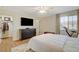 Spacious bedroom with a dresser, large TV, and walk-in closet at 2077 Via Firenze, Henderson, NV 89044