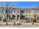 Tan two-story townhome with gray door, and a small front patio at 2077 Via Firenze, Henderson, NV 89044