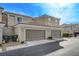 Tan two-story townhome with two-car garage at 2077 Via Firenze, Henderson, NV 89044