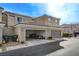 Tan two-story townhome with two-car garage at 2077 Via Firenze, Henderson, NV 89044