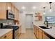 Modern kitchen with stainless steel appliances and light wood cabinets at 2077 Via Firenze, Henderson, NV 89044