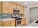 Modern kitchen with stainless steel appliances and light wood cabinets at 2077 Via Firenze, Henderson, NV 89044