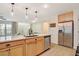 Kitchen island with a quartz countertop and stainless steel sink at 2077 Via Firenze, Henderson, NV 89044