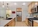 Modern kitchen with stainless steel appliances and light wood cabinets at 2077 Via Firenze, Henderson, NV 89044