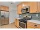 Modern kitchen featuring stainless steel appliances and light wood cabinets at 2077 Via Firenze, Henderson, NV 89044