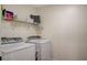 Bright laundry room with washer, dryer, and shelving at 2077 Via Firenze, Henderson, NV 89044