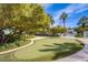 Landscaped putting green with surrounding trees and shrubs at 222 Karen Ave # 2308, Las Vegas, NV 89109